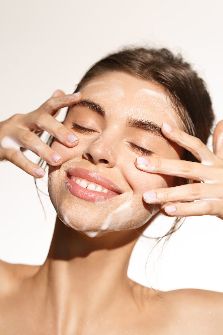 A lady washing her face with purifying gel cleanser