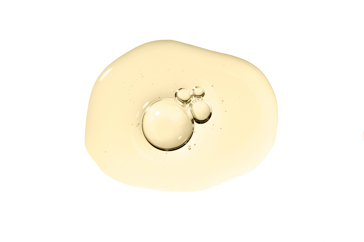 An oil swatch of Botanical Envy Restore body oil against a white background