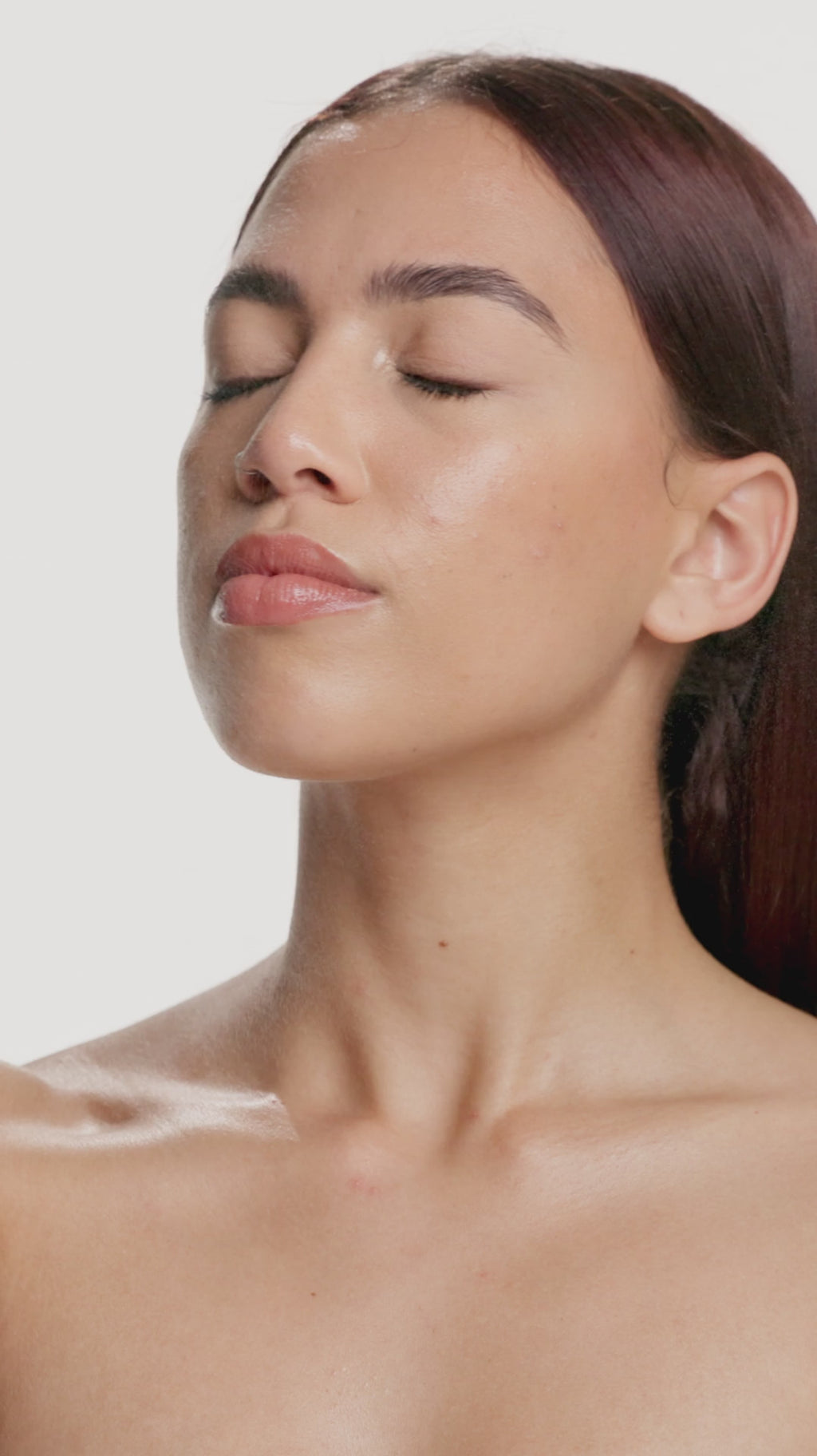 A lady spraying a mist on her face